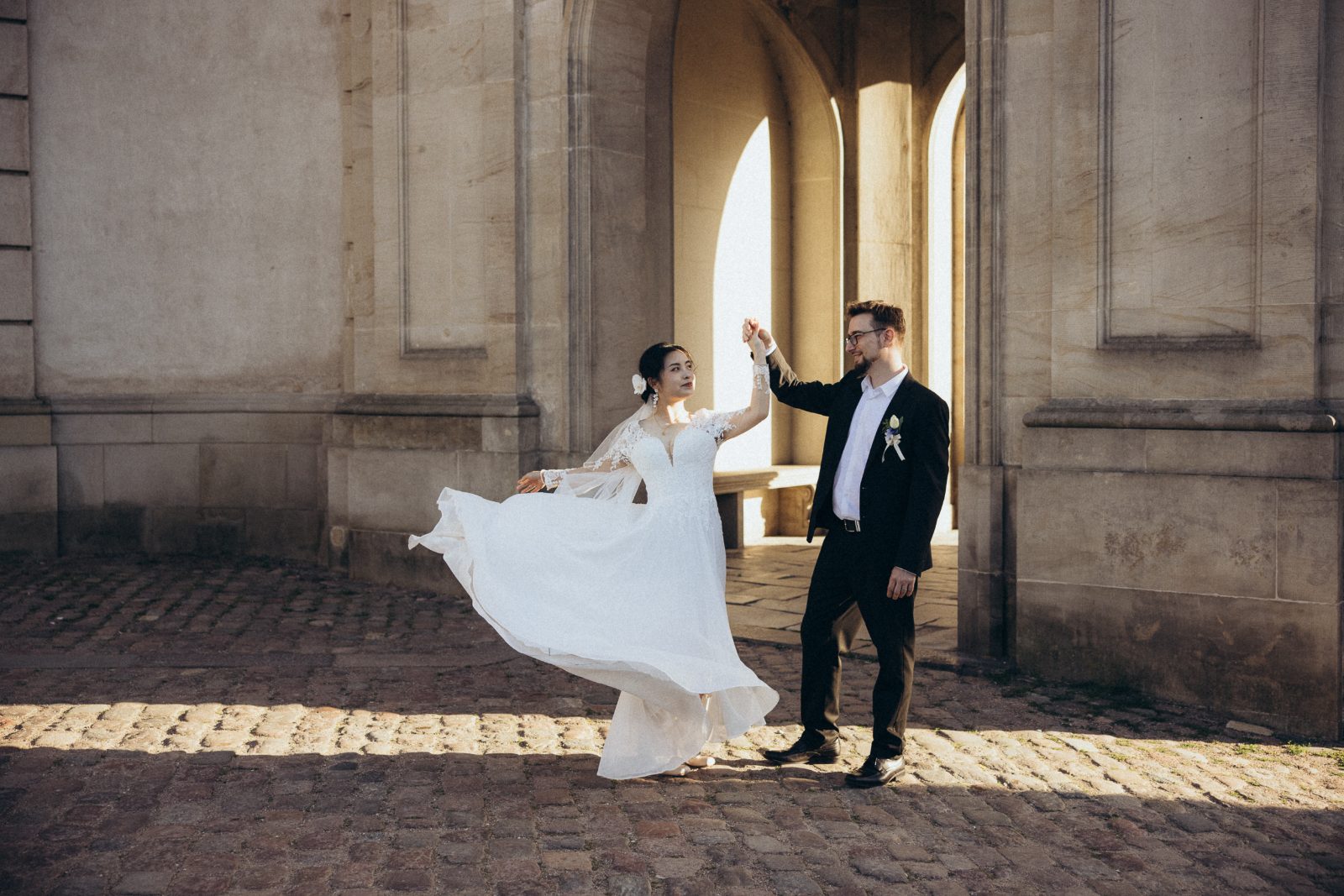 An unhurried embrace in soft evening light — a wedding day that feels lived-in, not staged