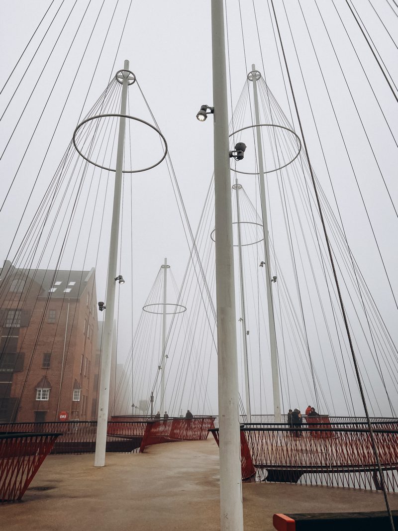 Ship masts and red benches on a foggy Christianshavn quay