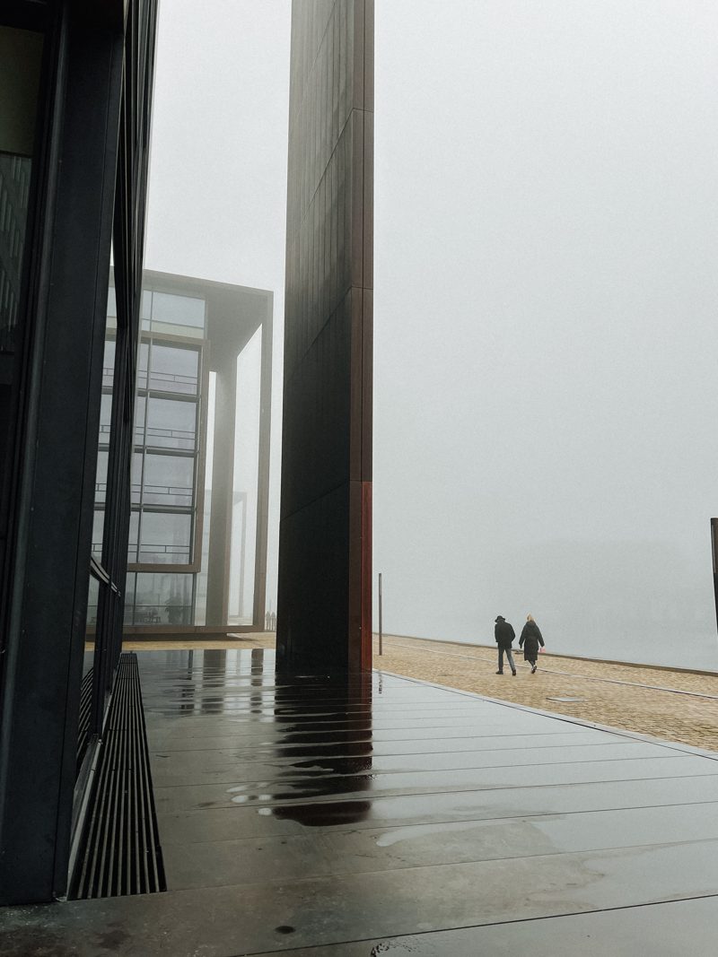 Modern waterfront architecture reflected on a wet promenade, Christianshavn