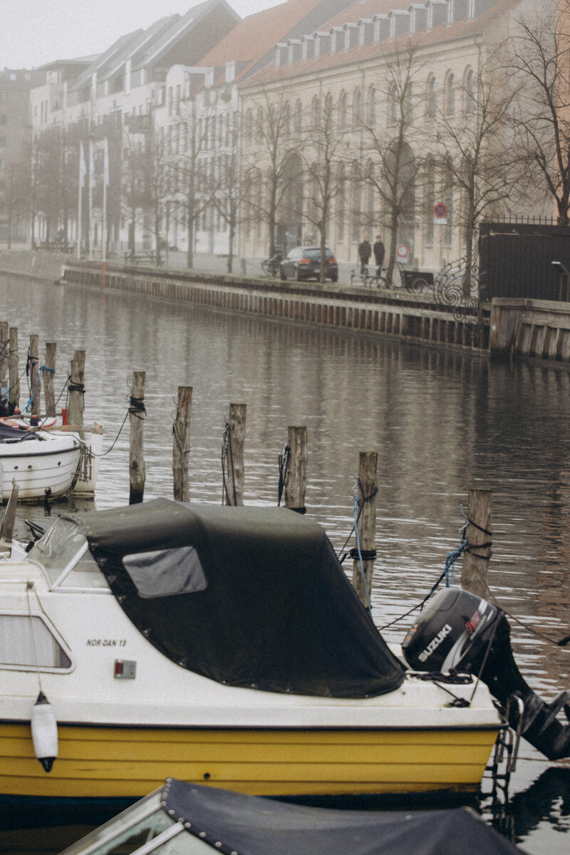 A moored boat in the misty Christianshavn canal