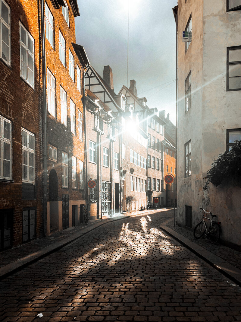 Sunlight flaring down the cobbled length of Magstræde