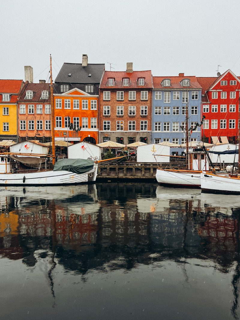 Colourful houses and boats mirrored in the canal