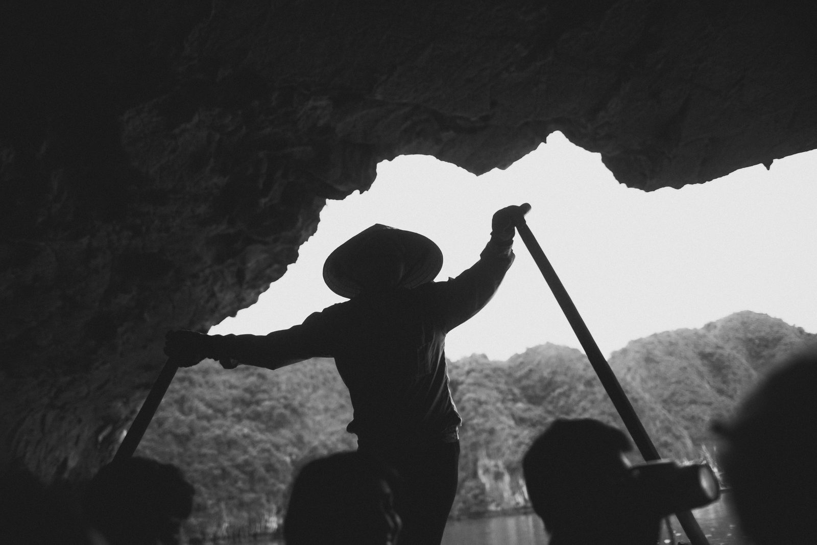 Silhouette of a rower in a cave, Ha Long Bay, Vietnam