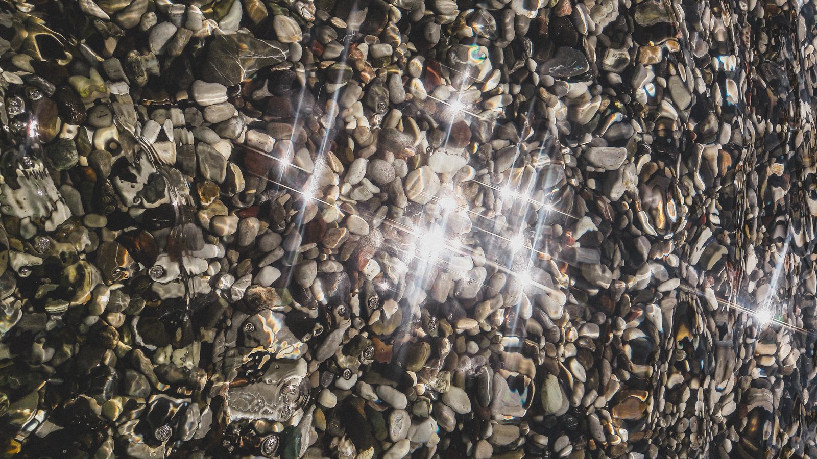 Sunlit pebbles on the beach, Kemer, Turkey