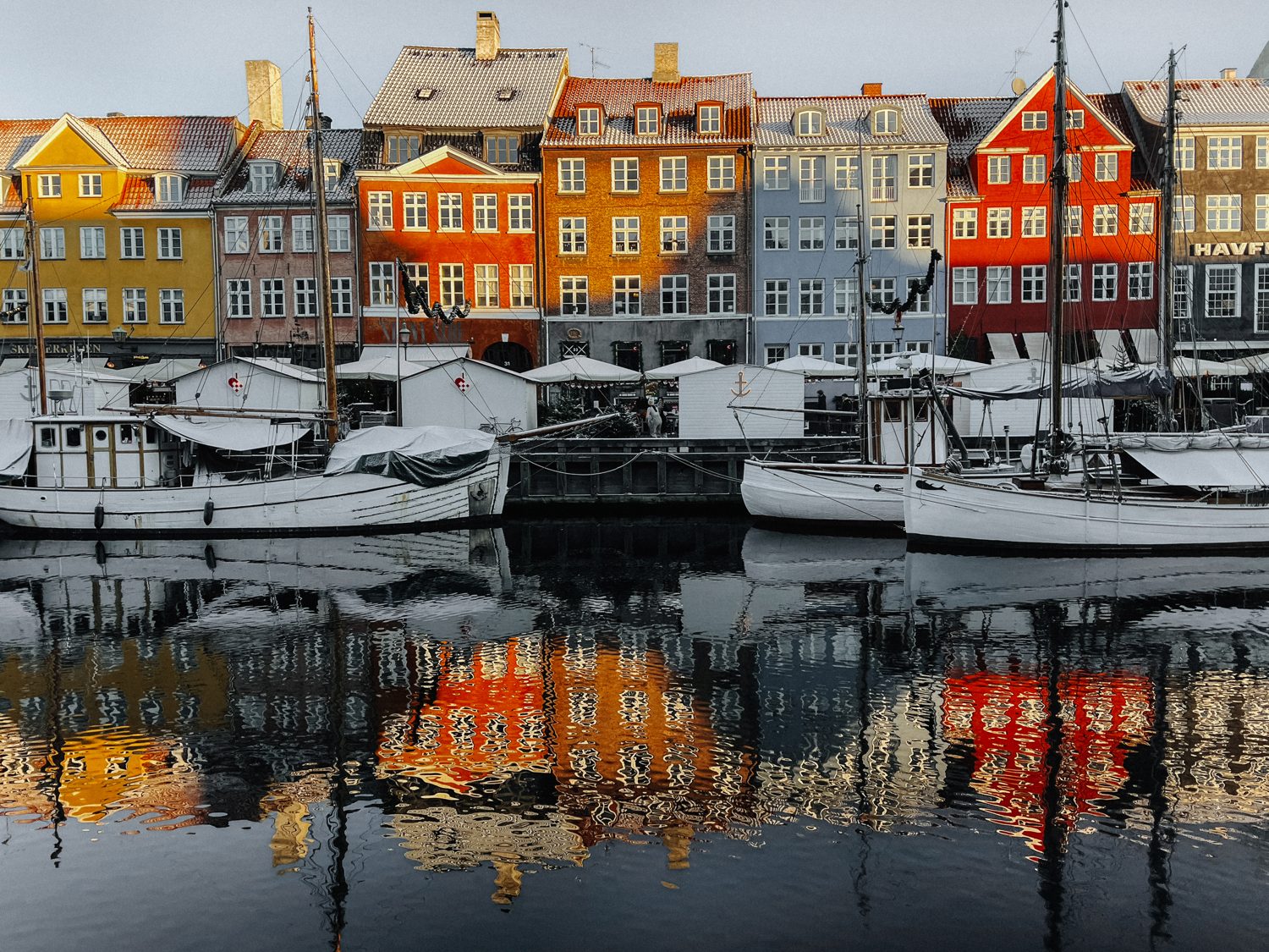 Colourful Nyhavn houses reflected in the canal, Copenhagen, Denmark